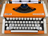 Typewriter, Orange Olympia Traveller de Luxe